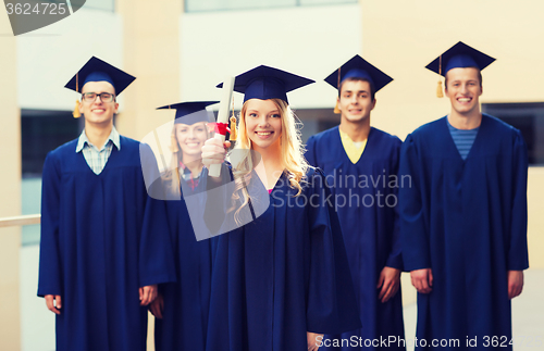 Image of group of smiling students in mortarboards