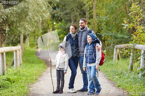 Image of happy family with backpacks hiking