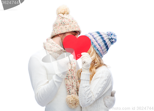 Image of smiling couple in winter clothes with red heart