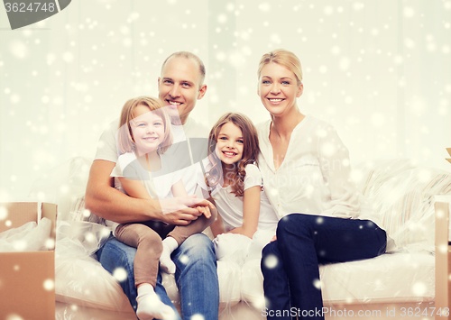 Image of smiling parents and two little girls at new home