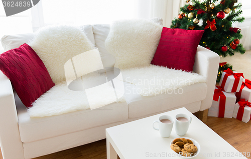 Image of close up of christmas cookies and cups on table