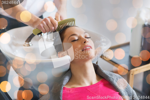 Image of happy young woman at hair salon