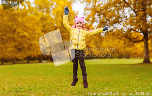 Image of happy little girl jumping outdoors