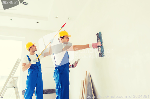 Image of group of builders with tools indoors