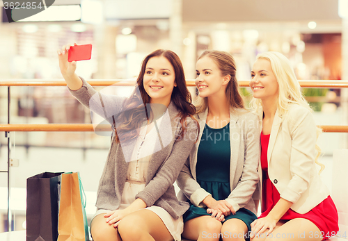 Image of women with smartphones shopping and taking selfie