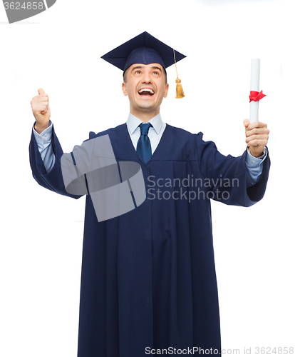 Image of smiling adult student in mortarboard with diploma