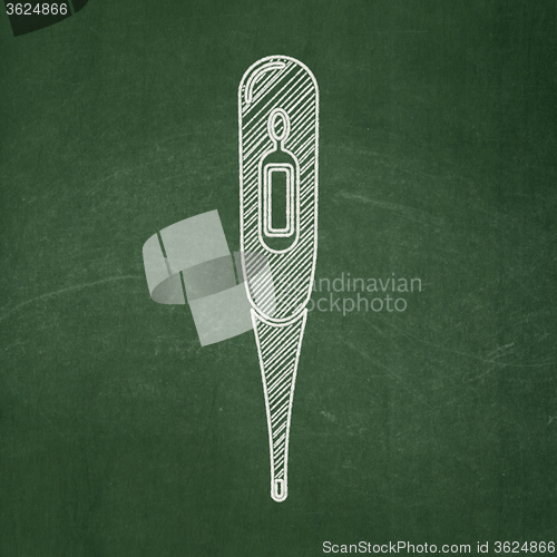 Image of Medicine concept: Thermometer on chalkboard background