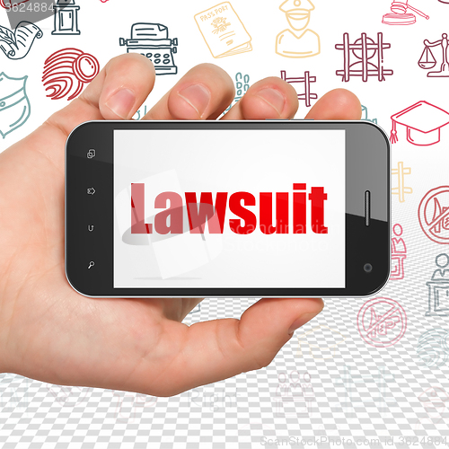 Image of Law concept: Hand Holding Smartphone with Lawsuit on display