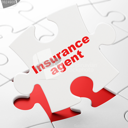 Image of Insurance concept: Insurance Agent on puzzle background