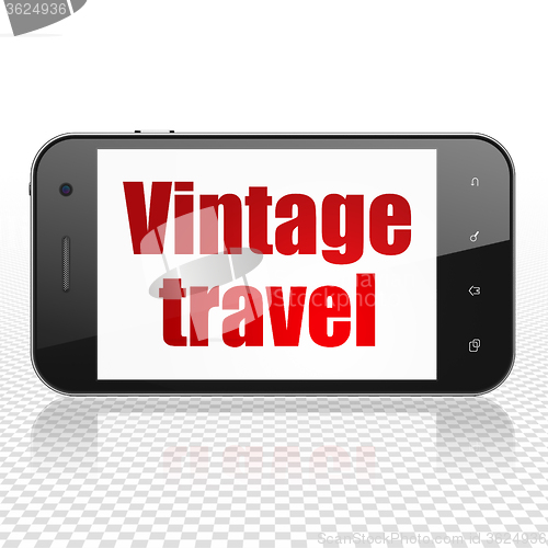 Image of Travel concept: Smartphone with Vintage Travel on display