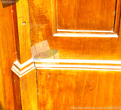 Image of grain texture of a brown antique wooden old door in italy   euro