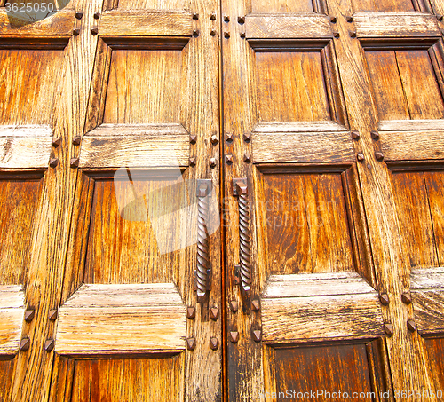 Image of abstract texture of a brown antique wooden old door in italy   e