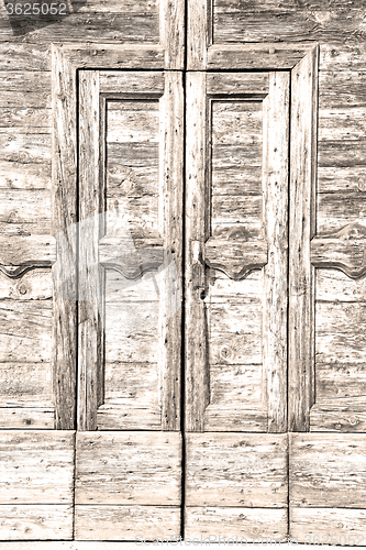 Image of grain texture of a brown antique wooden old door in italy   euro