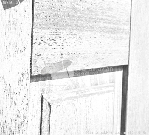 Image of abstract texture of a brown antique wooden old door in italy   e