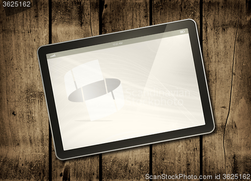Image of Digital tablet PC on a dark wood table
