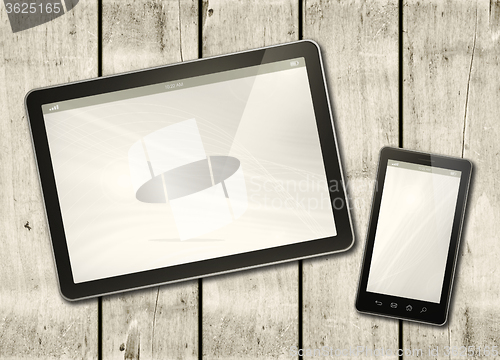 Image of Smartphone and digital tablet PC on a white wood table