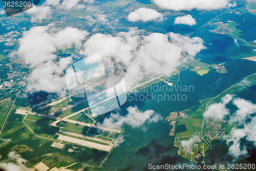 Image of Aerial view on international airport under clouds