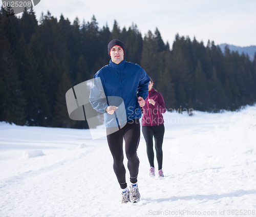 Image of couple jogging outside on snow