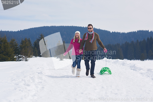 Image of happy young couple having fun on fresh show on winter vacation