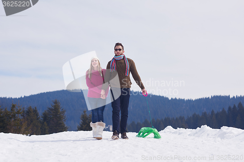 Image of happy young couple having fun on fresh show on winter vacation