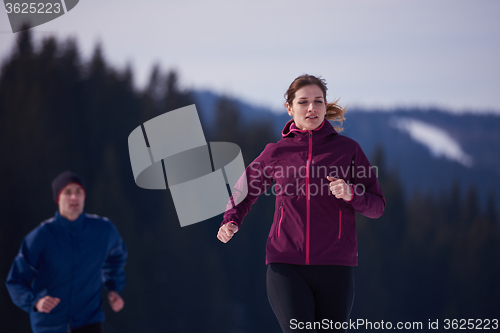 Image of couple jogging outside on snow