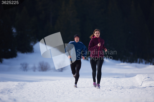 Image of couple jogging outside on snow