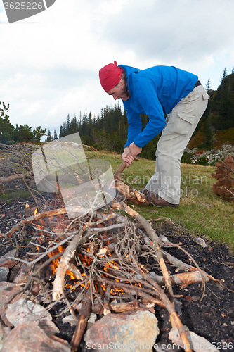 Image of hiking man try to light fire