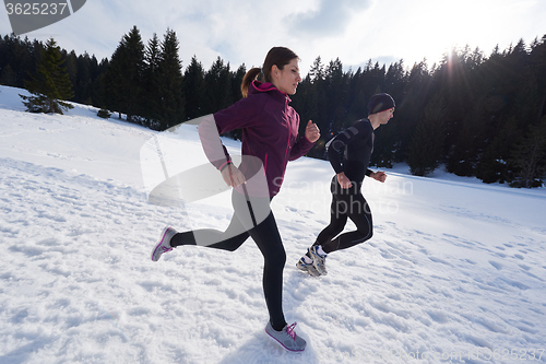 Image of couple jogging outside on snow