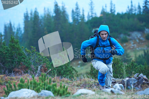 Image of advanture man with backpack hiking