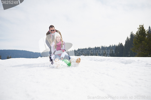 Image of happy young couple having fun on fresh show on winter vacation