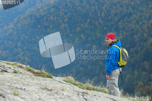 Image of advanture man with backpack hiking