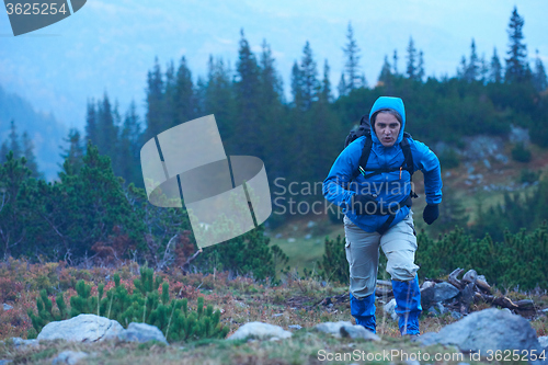 Image of advanture man with backpack hiking