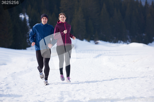 Image of couple jogging outside on snow