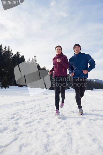 Image of couple jogging outside on snow