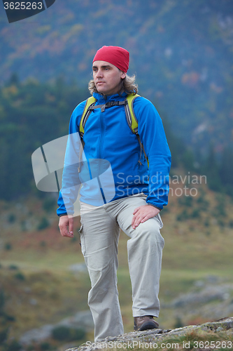 Image of advanture man with backpack hiking