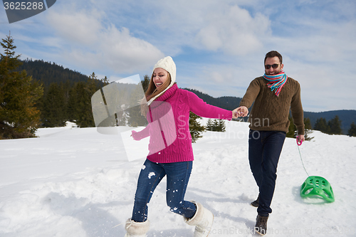 Image of happy young couple having fun on fresh show on winter vacation