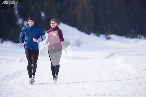 Image of couple jogging outside on snow