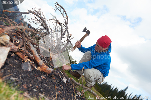 Image of hiking man try to light fire