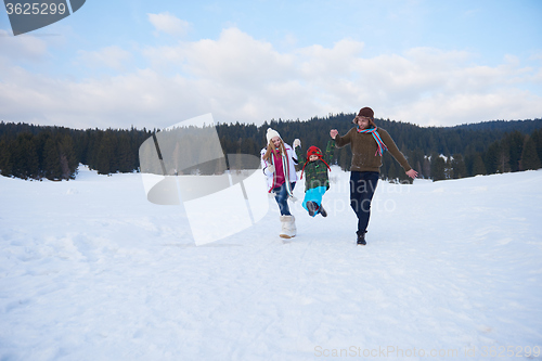 Image of happy family playing together in snow at winter