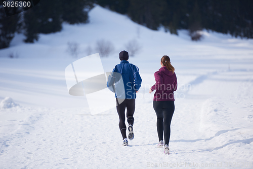 Image of couple jogging outside on snow