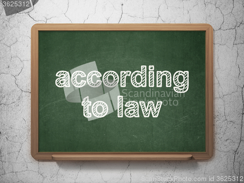 Image of Law concept: According To Law on chalkboard background
