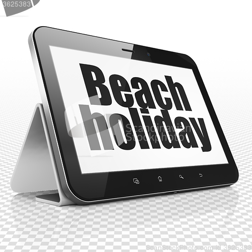 Image of Travel concept: Tablet Computer with Beach Holiday on display