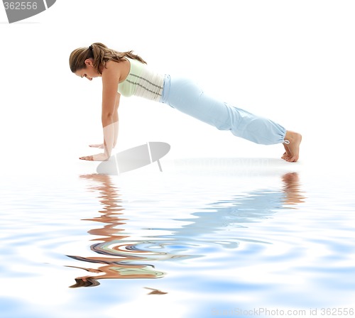 Image of chaturanga dandasana four-limbed staff pose on white sand