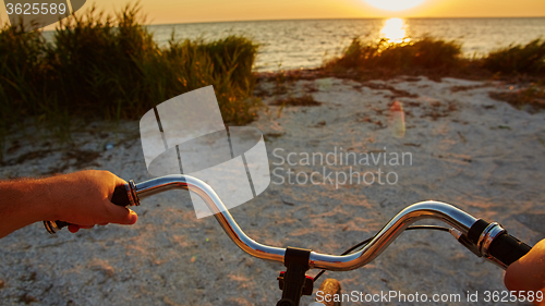 Image of Hands holding handlebar of bicycle