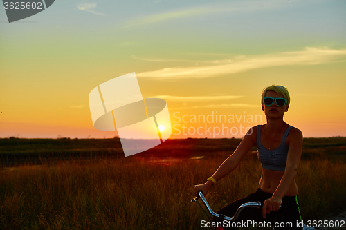 Image of Biker-girl at the sunset
