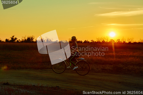Image of Biker-girl at the sunset