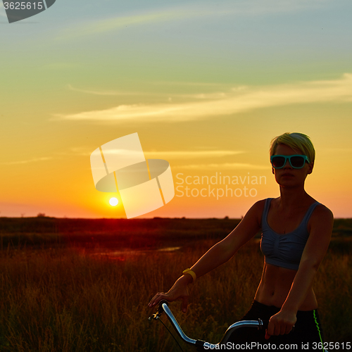 Image of Biker-girl at the sunset