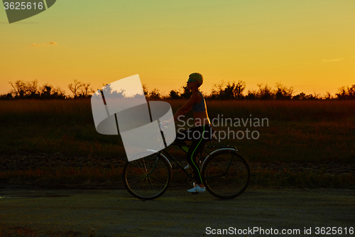 Image of Biker-girl at the sunset