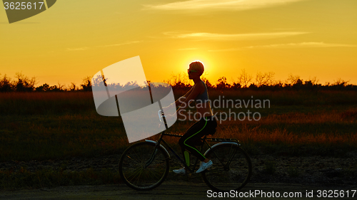 Image of Biker-girl at the sunset