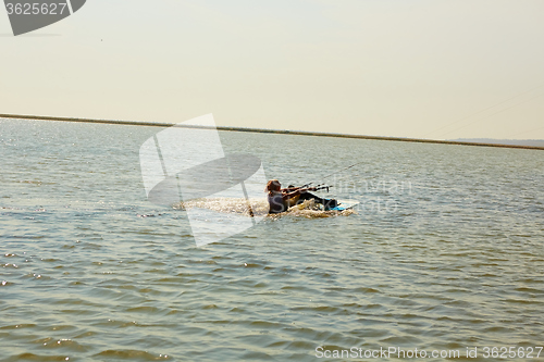 Image of young woman kite-surfer